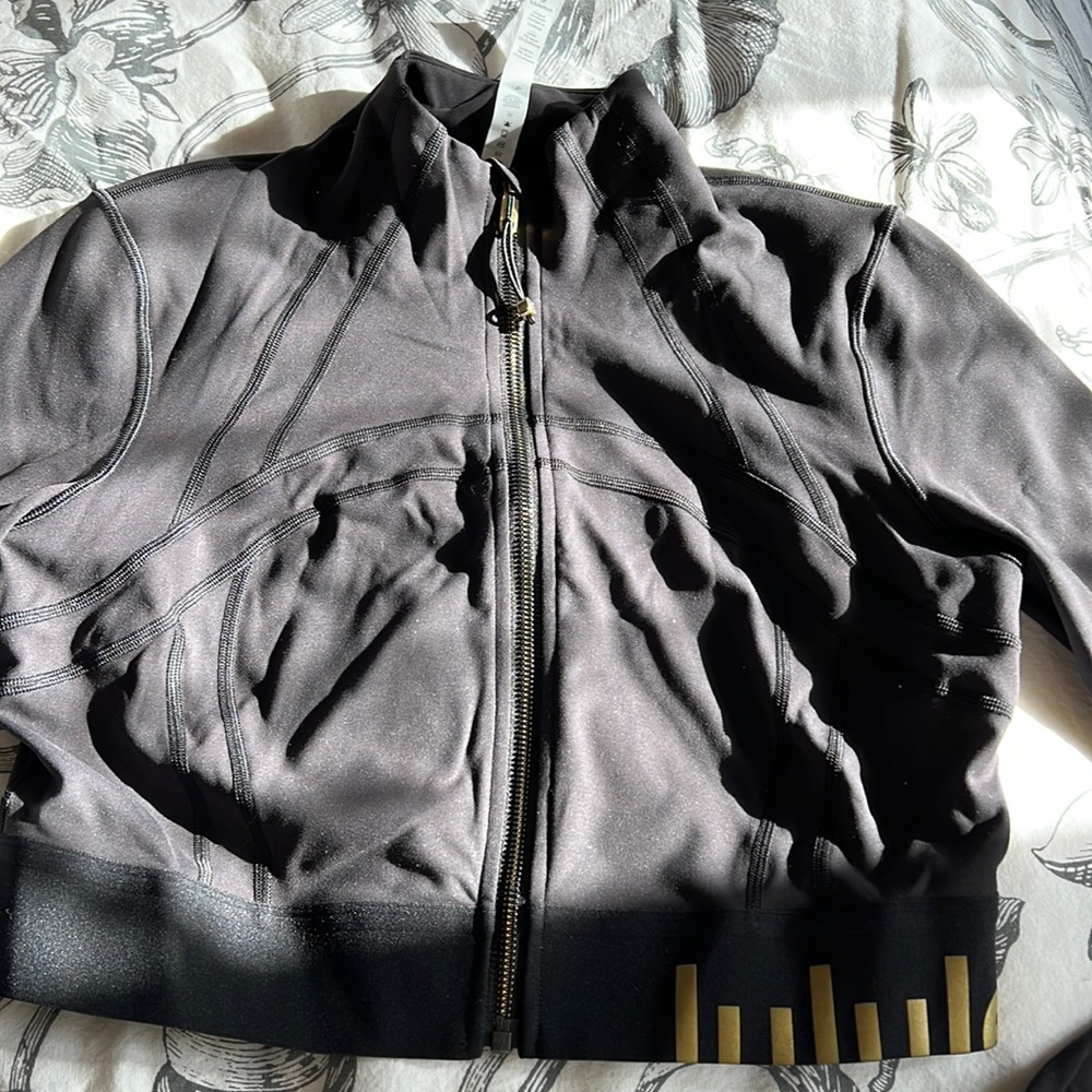 Black cropped retired Lululemon zip up.